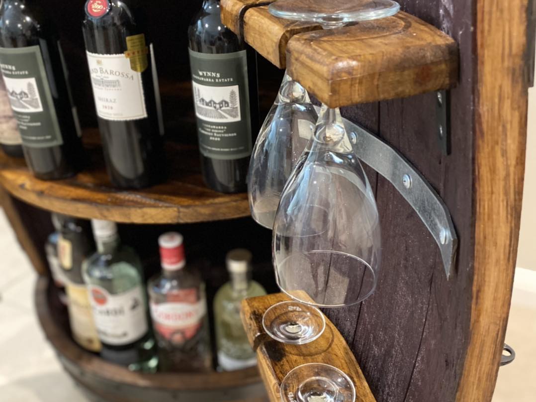 Handcrafted wine barrel mini bar with bottle and glass storage – rustic home bar furniture