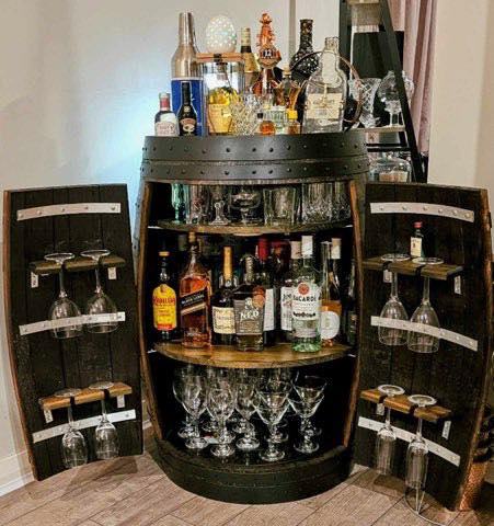 Full wine barrel bar displayed in home entertaining area with matching barrel furniture