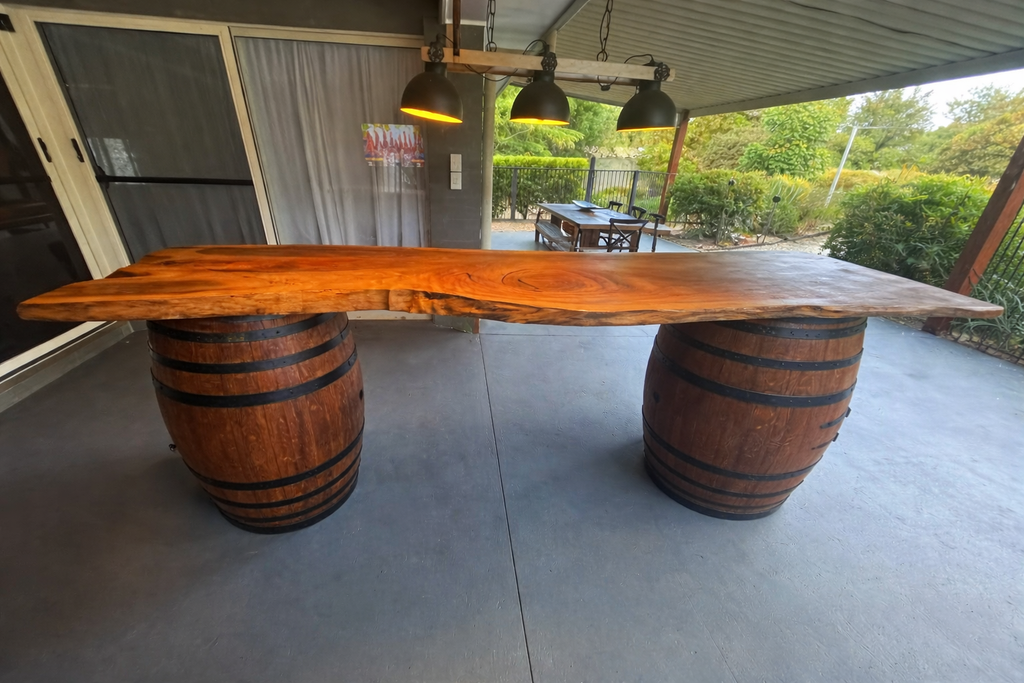 Double wine barrel live edge bar styled in home man cave entertaining space