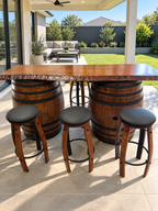 Two-barrel live-edge timber bar with matching wine barrel stave stools in a modern Australian backyard alfresco.