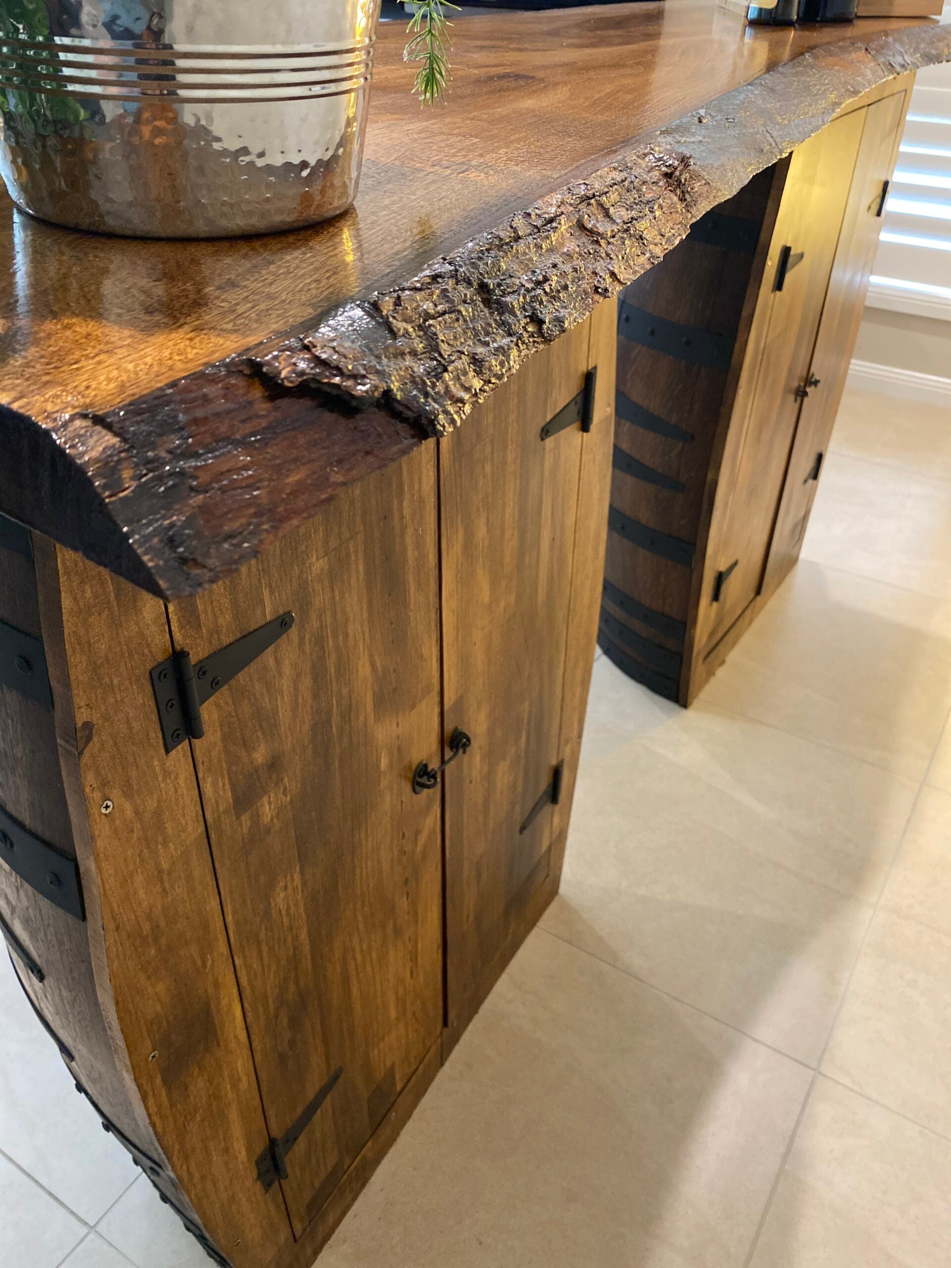 Rustic wine barrel bar with live edge wood slab top and hidden storage – handcrafted with built-in shelves for bottles and glassware