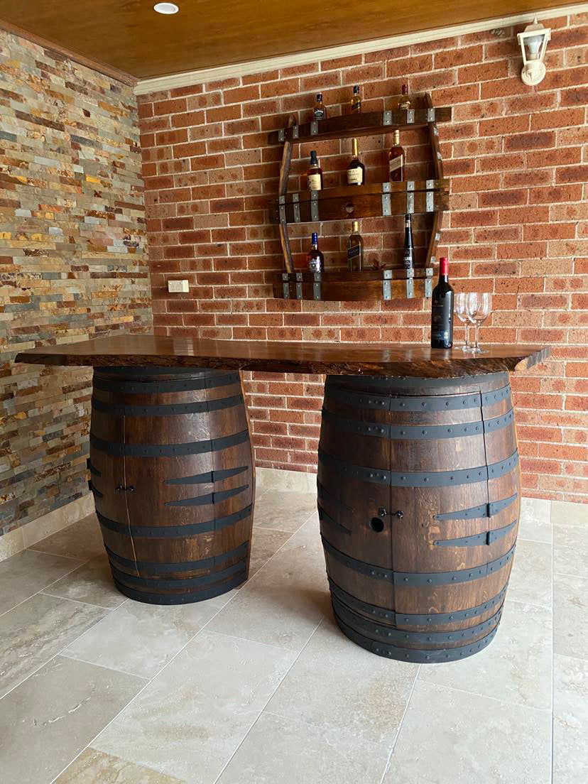 Rustic wine barrel bar with live edge wood slab top and hidden storage – handcrafted with built-in shelves for bottles and glassware