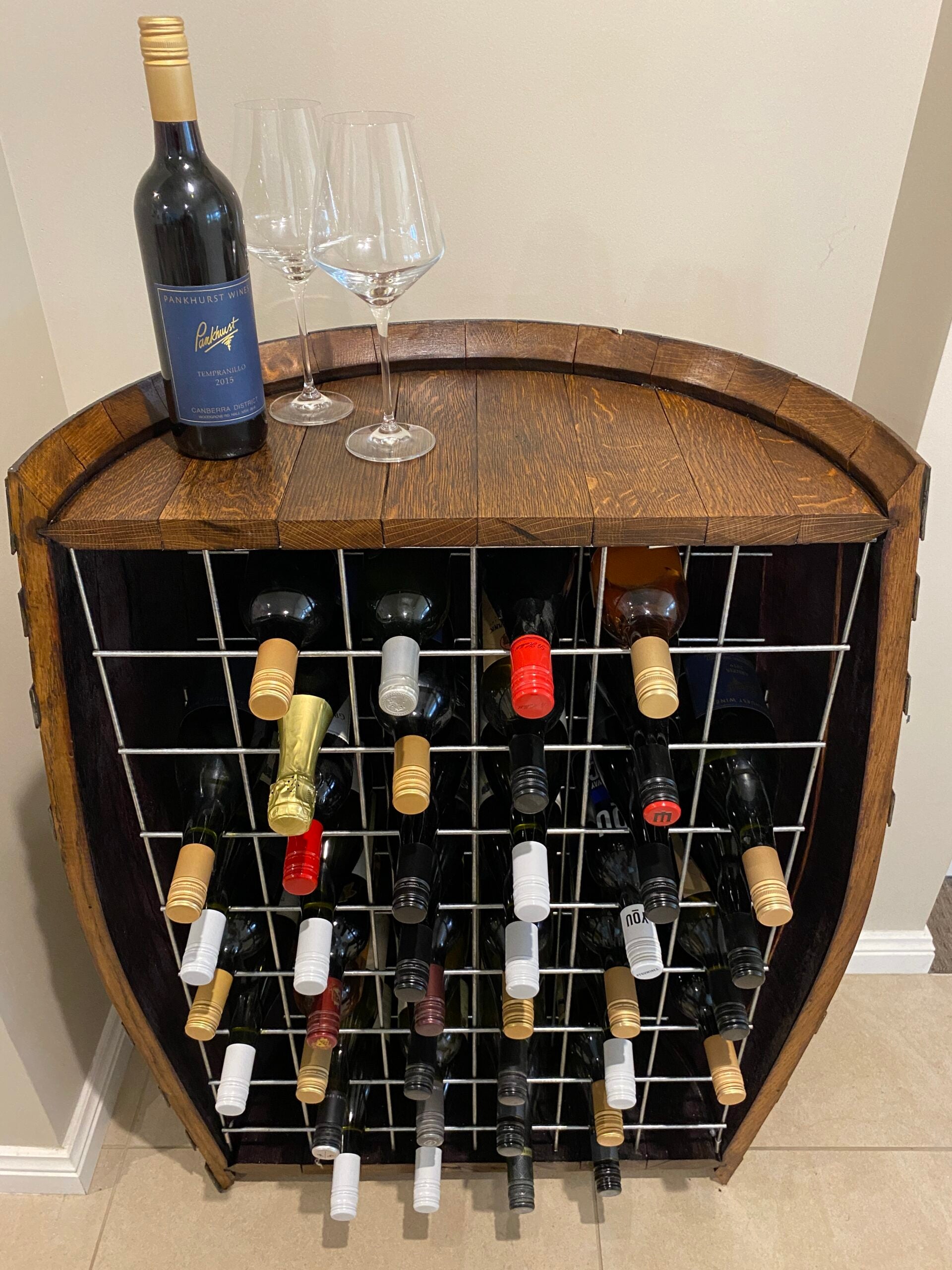 Freestanding wine barrel wine rack made from reclaimed oak, holds up to 40 bottles – rustic and sustainable wine storage solution