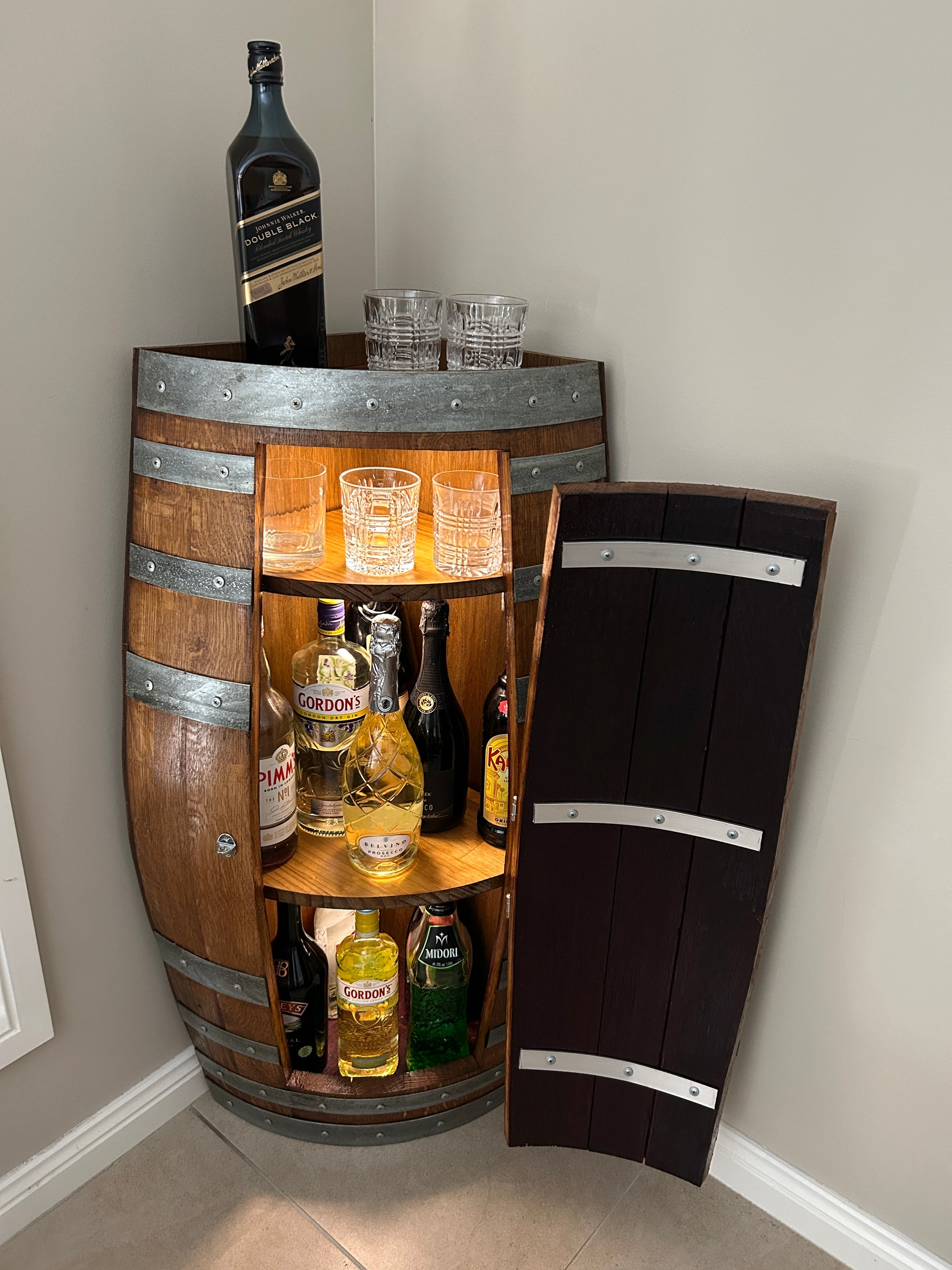 Handcrafted wine barrel mini bar with bottle and glass storage – rustic home bar furniture