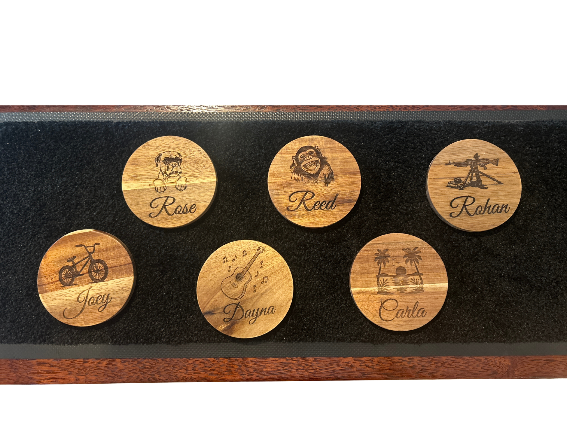 Set of six wooden coasters with engraved names and images on a black display stand.