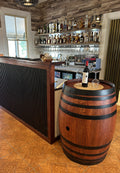 Refurbished full wine barrel with rich cedar finish and black steel bands, handcrafted from authentic oak wine barrels.