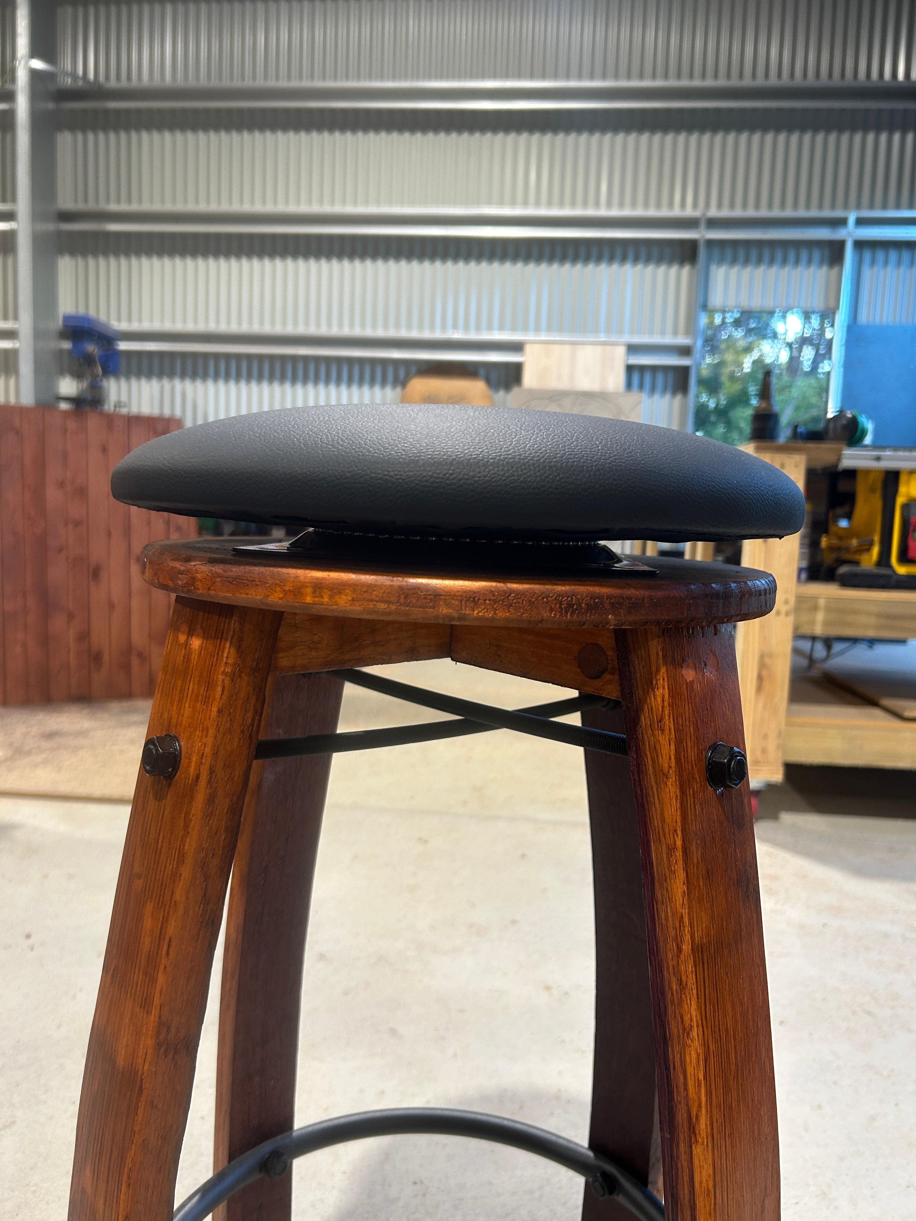 Close up of swivel mechanism on handcrafted wine barrel bar stool