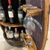Handcrafted wine barrel mini bar with bottle and glass storage – rustic home bar furniture